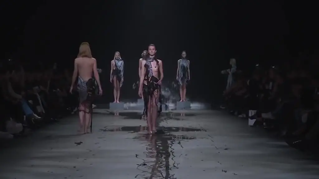 Inexplicable fashion show with models nearly naked on the catwalk