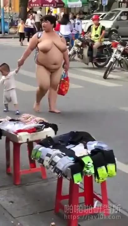 A bold mother shows off her child in the street... all naked